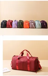 Detail of multi-color nylon duffel bags with adjustable shoulder straps and side zipper pockets