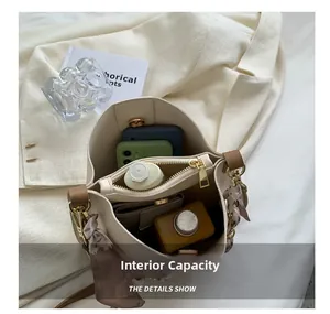 Top view of cream bucket bag showing spacious interior with a removable zipper pouch