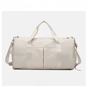 Front view of large beige fitness travel bag with adjustable strap and waterproof fabric