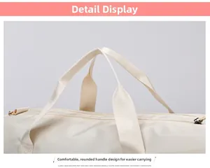 Detail of reinforced handles and gold hardware on a beige travel fitness duffel bag
