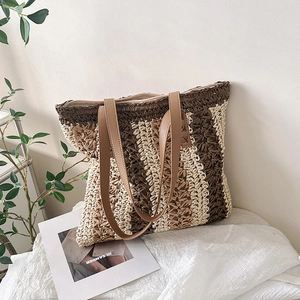 Large woven tote bag with colorful stripes and brown leather straps for summer beach travel