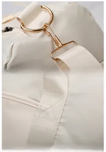 Detail of gold metal hooks and reinforced cross-stitch on the large travel tote bag