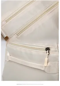 Detail of smooth double zippers and durable nylon handles on the large travel bag