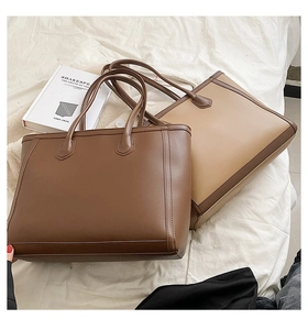 Minimalist tote bags in brown and apricot PU leather displayed on a soft fabric surface