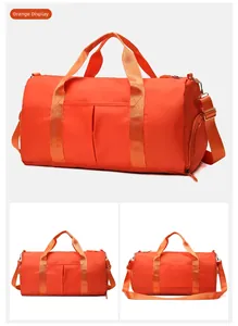 Detail view of orange waterproof fitness bag with shoe compartment and adjustable strap