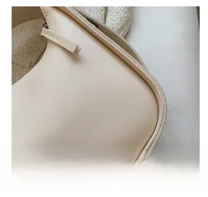Detail of cream leather bag with fashion bag engraving and fine stitching craft