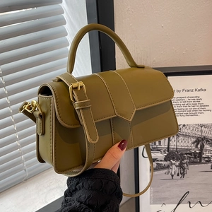 Olive green minimalist crossbody bag with gold buckle and top handle in studio lighting