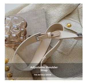 Detail of adjustable beige leather shoulder strap with a silver metal buckle for handbags