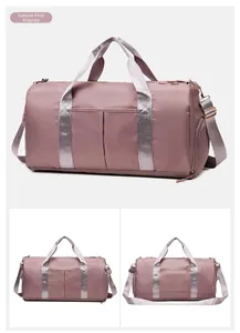 Detail view of pink waterproof travel bag with wet-dry separation pocket and shoulder strap