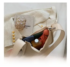 Interior view showing capacity of this cream white shoulder bag with daily essentials