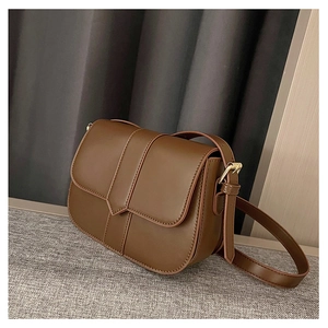 Detailansicht der braunen Satteltasche aus Leder mit goldenen Schnallen und Riemen