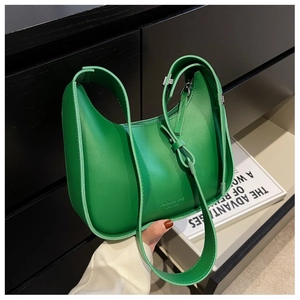 Detail of emerald green crescent bag in matte leather featuring fashion bag logo