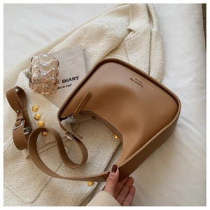 Detailed view of brown leather hobo bag with Fashion bag NEW YORK text and zipper