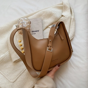 Caramel half-moon underarm bag in premium faux leather with minimalist printed design