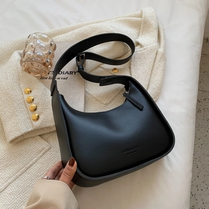 Minimalist black crescent hobo bag with adjustable strap and fashion lettering