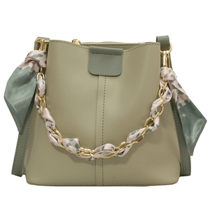 Sage green bucket bag with gold chain handle, floral silk scarf and leather strap
