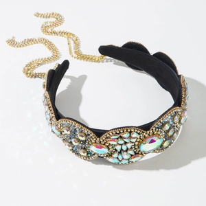 Detailed macro view of Baroque wide headband with iridescent rhinestones and gold chain