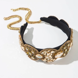 Macro shot of Baroque luxury velvet headband with champagne crystals and golden beadwork
