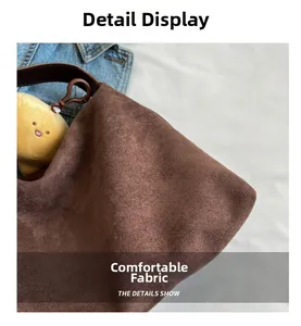 Close-up of premium brown suede tote bag fabric showing fine texture and matte finish