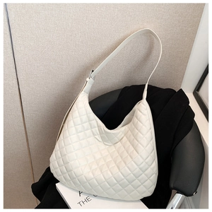 Detailed view of the white quilted hobo bag featuring soft texture and adjustable shoulder strap