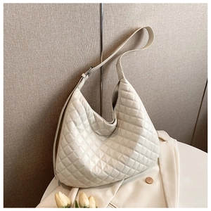 Close-up of beige quilted leather hobo bag with elegant diamond stitching details