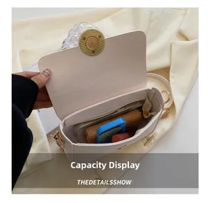 Internal view of a cream crossbody bag showing capacity for phone and wallet