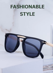 Detail of square polarized folding sunglasses with gold metal arrow accents on black frame