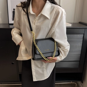 Elegant black crossbody bag with gold chain strap and flap closure for women