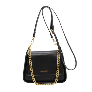 Classic black leather crossbody bag with gold chain and Muon & Shark logo branding