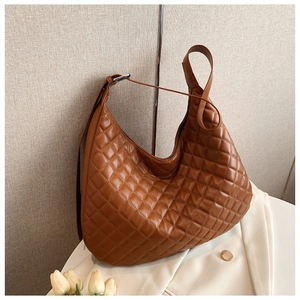 Detail view of brown quilted hobo bag with classic diamond stitching and silver buckles