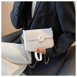 Detailed view of white matte PU leather square bag with gold chain and circular buckle