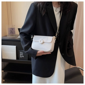 Minimalist white leather crossbody bag with round buckle and golden chain strap detail