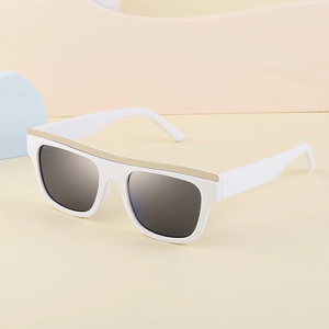 Detail of white square cat-eye sunglasses with gold metal trim and dark lenses