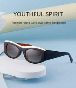 Detail of black cat eye sunglasses with ivory top accent and amber inner temples