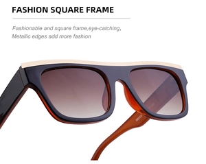 Detail of square black sunglasses with golden metal trim and gradient brown lenses