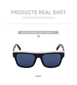Detailed front shot of black cat-eye sunglasses with luxury gold metal top trim accents