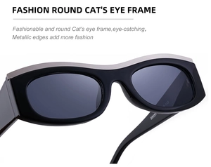 Detail of black cat eye sunglasses with silver metal trim and dark grey lenses