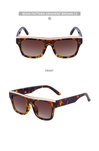 Macro view of tortoiseshell cat-eye sunglasses with gradient brown lenses and gold brow bar