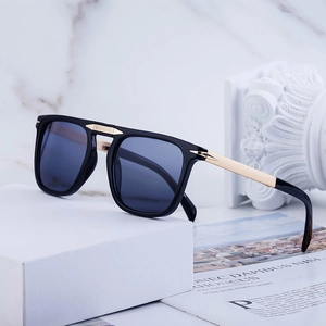 Classic square folding polarized sunglasses with gold arrow accents on marble background