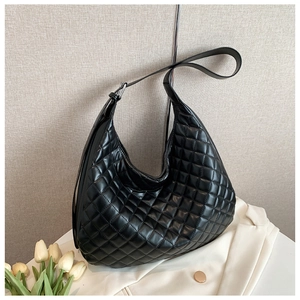 Close-up of black quilted hobo bag featuring elegant diamond pattern and adjustable strap