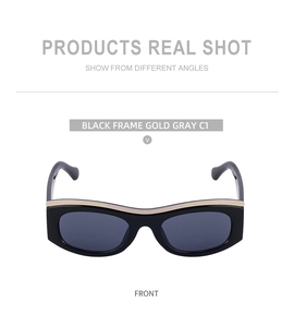 Front view of black cat eye sunglasses with gold brow bar and dark gray lenses