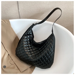 Detail shot of black quilted large capacity hobo bag with adjustable shoulder strap