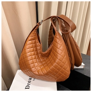 Detail of brown quilted hobo bag featuring premium faux leather and silver metal hardware