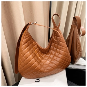Detail of brown quilted hobo shoulder bag with textured faux leather and spacious design
