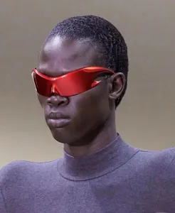 Close-up of red flame-shaped wrap sunglasses with futuristic metallic finish on male model