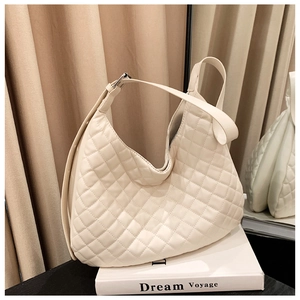 Detail of off-white quilted hobo bag with adjustable strap and silver metal hardware