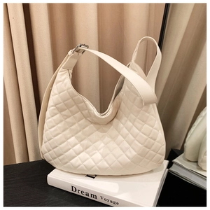 Detailed view of white quilted stitching on a soft faux leather shoulder hobo bag