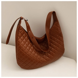 Detailed view of caramel brown quilted hobo bag with adjustable strap and metallic hardware