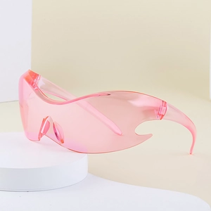 Pink Y2K futuristic sports sunglasses with flame-cut wrap lens on a geometric stand