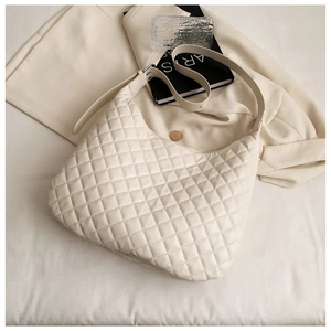 Detail of off-white quilted hobo shoulder bag with sleek faux leather and stitching